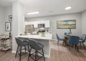Thumbnail 16 of 67 - an open kitchen and dining area with a table and chairs