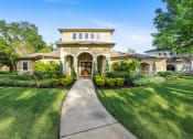 Thumbnail 66 of 67 - a house with a walkway and lawn in front of it