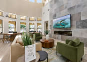 Thumbnail 32 of 67 - a living room with couches and chairs and a fireplace