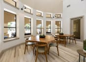 Thumbnail 35 of 67 - a dining room with a wooden table and chairs and windows