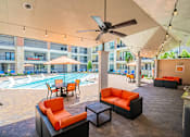Thumbnail 8 of 35 - A patio with a pool and furniture.