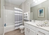 Thumbnail 21 of 67 - a bathroom with a shower and a sink and a toilet