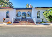 Thumbnail 28 of 28 - a white building with three doors and three windows