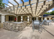 Thumbnail 60 of 67 - a patio with a bar and tables and chairs