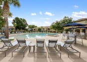 Thumbnail 54 of 67 - a swimming pool with chairs and umbrellas next to a resort style pool