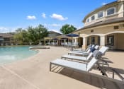 Thumbnail 59 of 67 - a pool and patio with chairs and umbrellas in front of a house