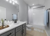 Thumbnail 24 of 39 - a bathroom with a sink and a toilet and a shower