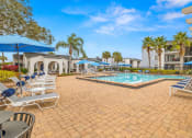 Thumbnail 21 of 29 - a resort style swimming pool with lounge chairs and umbrellas