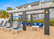 Thumbnail 25 of 29 - a patio with lounge chairs and a pergola