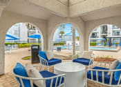 Thumbnail 23 of 29 - a patio with chairs and tables and a pool