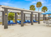 Thumbnail 22 of 29 - a covered patio with lounge chairs and umbrellas
