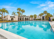 Thumbnail 19 of 29 - a large pool in front of a house with palm trees