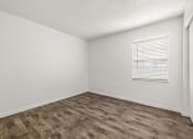Thumbnail 10 of 29 - the spacious living room with wood flooring and a window