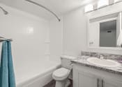Thumbnail 12 of 29 - a bathroom with a sink toilet and a mirror