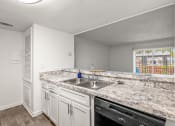 Thumbnail 3 of 29 - a kitchen with white cabinets and granite counter tops and a sink
