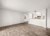 Thumbnail 6 of 29 - an empty living room and kitchen with wood flooring