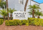 Thumbnail 29 of 29 - a sign for hanley place apartments in front of palm trees