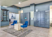 Thumbnail 33 of 40 - A room with blue chairs and a white table.