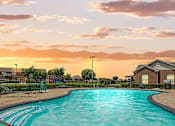 Thumbnail 10 of 16 - A large swimming pool with a sunset in the background.