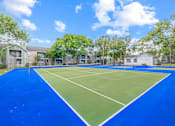 Thumbnail 48 of 51 - A tennis court with a blue surface and white lines.