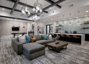 Thumbnail 11 of 23 - a living room with a large couch and a table
