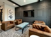 Thumbnail 10 of 23 - a living room with leather couches and a tv