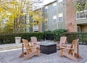 Thumbnail 4 of 22 - our apartments have a patio with chairs and a fire pit