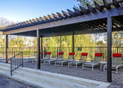 Thumbnail 3 of 22 - a group of chairs under awning in a park