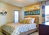 Thumbnail 19 of 22 - a bedroom with a bed and a painting on the wall