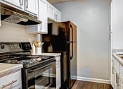 Thumbnail 17 of 22 - a kitchen with a stove and a refrigerator
