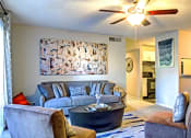 Thumbnail 15 of 22 - a living room with a couch and a coffee table