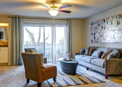Thumbnail 16 of 22 - a living room with a couch and chair and a ceiling fan