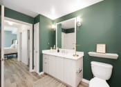 Thumbnail 11 of 66 - a bathroom with a toilet and a sink and a mirror