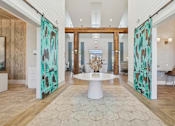 Thumbnail 5 of 26 - A room with a white table in the middle and two green patterned curtains on the sides.