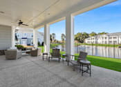 Thumbnail 24 of 26 - A patio with a table and chairs is shown.