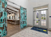 Thumbnail 4 of 26 - A room with a blue mat on the floor and a glass door.