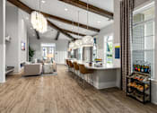 Thumbnail 6 of 26 - A modern kitchen with a dining area and a living room.