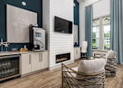 Thumbnail 8 of 26 - A modern living room with a fireplace and a TV mounted on the wall.