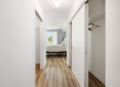 Thumbnail 16 of 66 - a bedroom with white walls and white doors and a bed