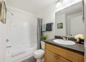 Thumbnail 35 of 41 - a bathroom with a shower toilet and sink and a mirror
