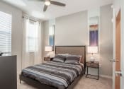 Thumbnail 19 of 45 - a bedroom with a bed and a ceiling fan