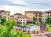Thumbnail 6 of 13 - a view of a courtyard with a pool and some buildings
