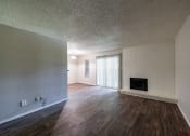 Thumbnail 2 of 26 - a living room with hardwood floors and a fireplace