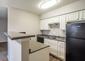 Thumbnail 5 of 26 - a kitchen with white cabinets and black appliances