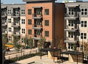 Thumbnail 26 of 27 - A pool in front of apartment buildings.