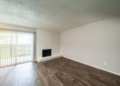 Thumbnail 3 of 26 - a bedroom with hardwood flooring and a fireplace