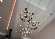 Thumbnail 25 of 27 - A modern chandelier hangs from the ceiling in a spacious room.