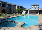 Thumbnail 25 of 26 - a swimming pool with a building in the background