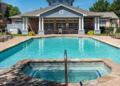 Thumbnail 22 of 26 - a swimming pool with a house in the background