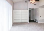 Thumbnail 2 of 36 - a room with white walls and white furniture and a white door